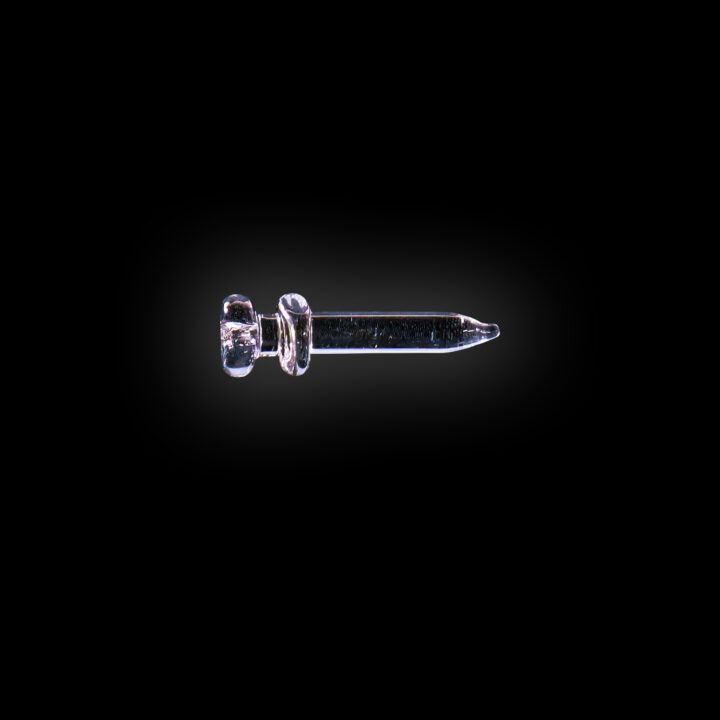 A black background with a single earring in the middle of it.