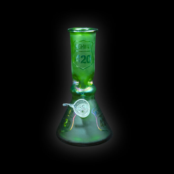 A green glass beaker with a black background
