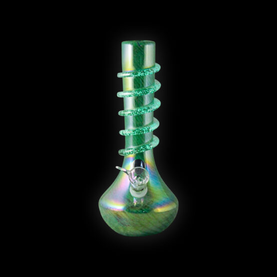 A green glass pipe is sitting on the ground.