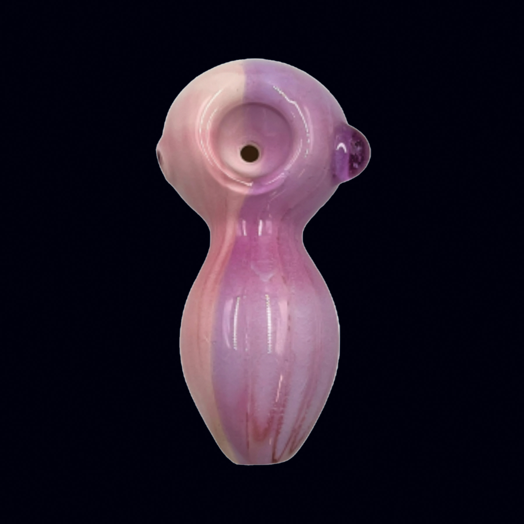 A pink glass figurine with a black background